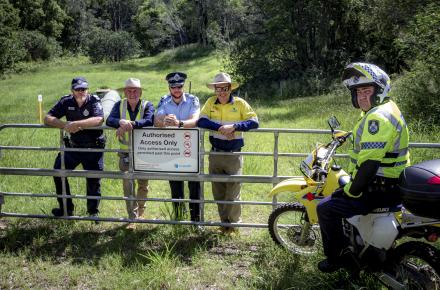 Representatives from Queensland Police and Seqwater at the site of the newly installed fence at Mt Crosby
