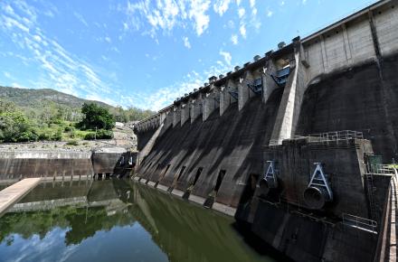 A picture of the Somerset Dam Spillway with three gates and eight sluice tunnels on a sunny day