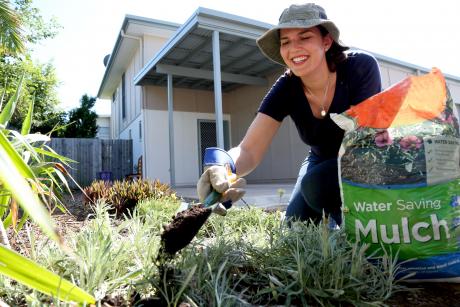 Raceview resident Susan Woodford uses mulch as a water saving measure to help her plants retain water during the hot days