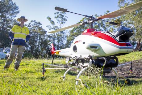 Seqwater Biosecurity Officer Jessica Doman with the Yamaha RMax drone helicopter at Wappa Dam