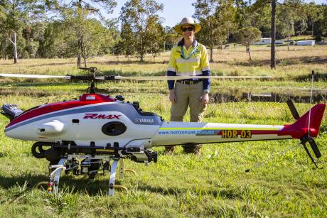 Seqwater Biosecurity Officer Jessica Doman with the Yamaha RMax drone helicopter at Wappa Dam