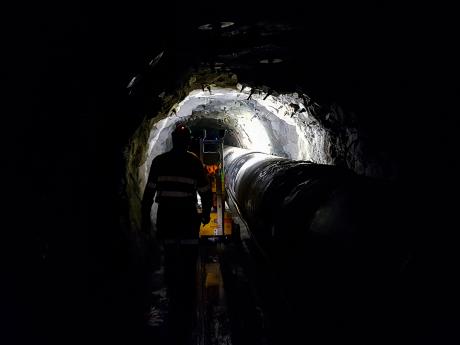 Workers inside the Blackall Range tunnel which houses a critical bulk water pipeline