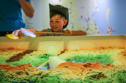 Young child learning about water at Seqwater's augmented sandpit