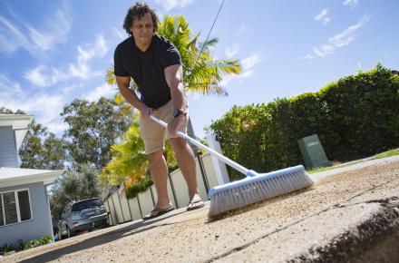 Northgate resident Tyrone Williams 3, saves water by sweeping his driveway rather than use a hose.