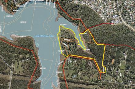 Outline in yellow of area between the shoreline of Leslie Harrison Dam and Degen Rd subject to a planned burn
