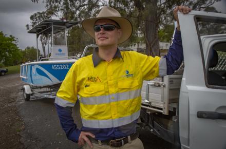 Seqwater Compliance Officer Pat McEvoy with one of Seqwater's boats. Seqwater field rangers and compliance officers are receiving repeated callouts to assist stranded boats.