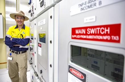 Seqwater COO Stuart Cassie stands next to the recently installed High Voltage Switchboard at North Pine Water Treatment Plant.jpg